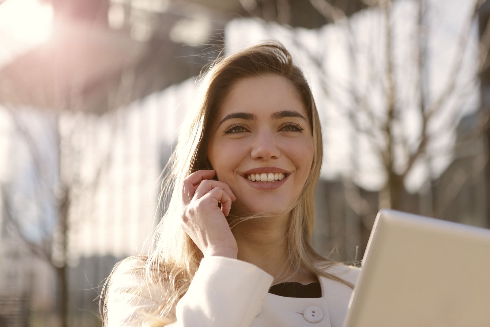 Smiling woman talking on the phone outdoors
