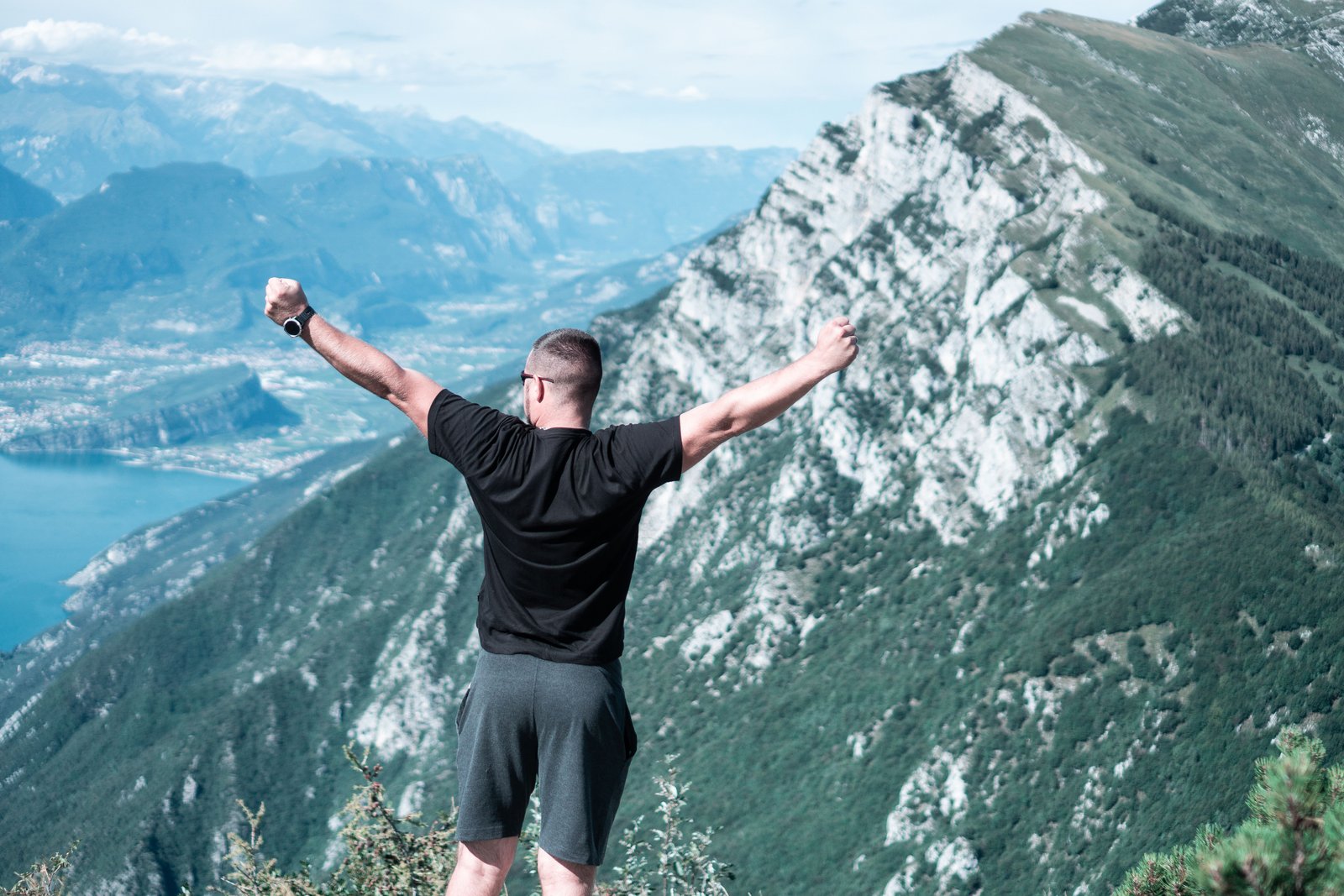 Man celebrating outdoors with arms raised